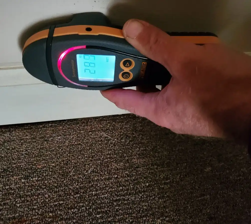 Moisture detection at baseboard during Storm Damage Restoration in Greenwood Village